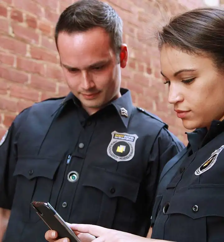 Security Officers checking a mobile phone.