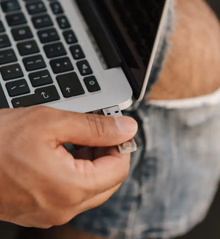 Worker inserting USB stick into port